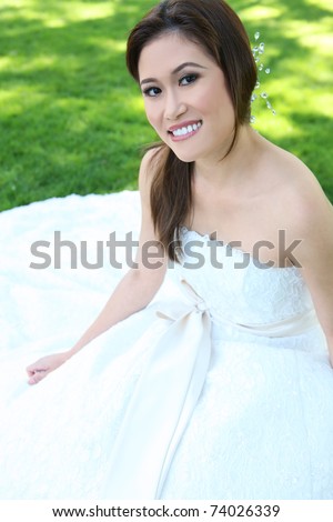 A beautiful young asian bride at wedding ceremony in the park