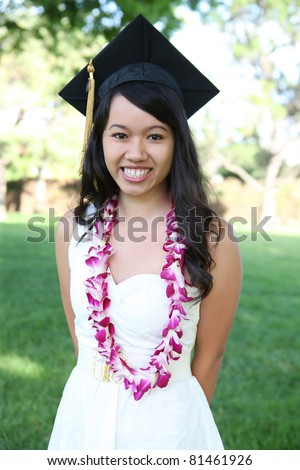 A pretty young asian woman outside at college graduation
