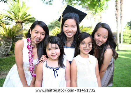 An asian family of girls and sisters celebrating a college graduation