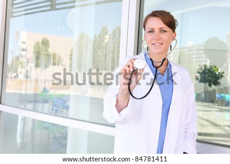 A young, pretty woman nurse at hospital building
