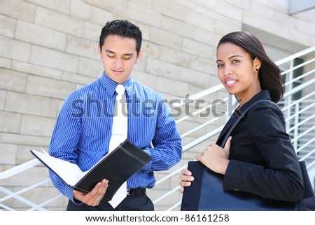 A diverse man and woman business team at their company office building