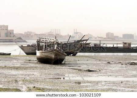 Dhow, traditional fishing boat lying on sea bed during low tide