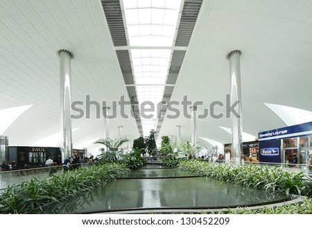 DUBAI INTERNATIONAL AIRPORT, DUBAI-AUGUST 25: A beautiful artificial garden inside Dubai International Airport on  August 25, 2012. Dubai International Airport is one of the fastest growing major hubs