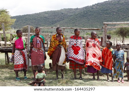 MASAI MARA, KENYA-OCTOBER 19: Masai women in traditional dress performs traditional folk dance at a Masai Mara Village, Kenya on October 19, 2013