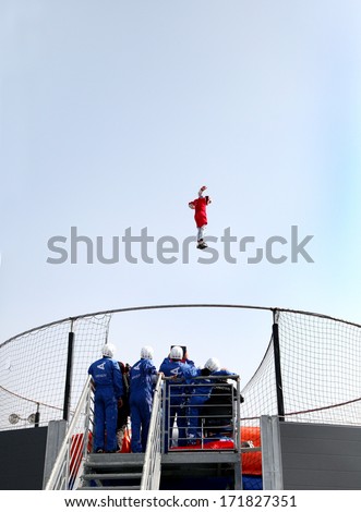 SAKHIR AIRBASE, BAHRAIN  - JANUARY 17: A person showing acrobatic on Aerodium, a vertical wind tunnel at the venue  of Bahrain International Airshow at Sakhir Airbase, Bahrain on 17 January, 2014