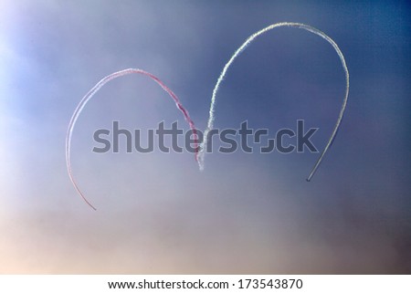SAKHIR AIRBASE, BAHRAIN - JANUARY 16: Al Fursan aircrafts makes a heart shape jet smoke trail during flying display in Bahrain International Airshow at Sakhir Airbase, Bahrain on 16 January, 2014