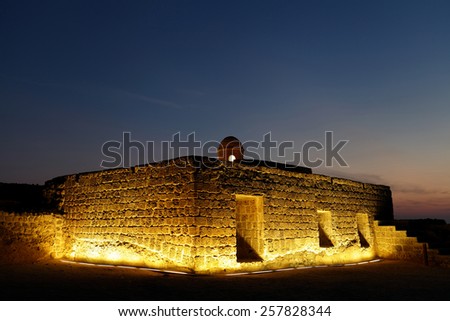 Illuminated Ancient watch tower and rooms at the upper level of Bahrain fort