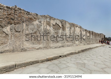 NAPLES, ITALY - JULY 17: Tourists visits the excavated ruins of Pompeii city on July 17, 2015, Naples, Italy. The city was buried under ash and debris during the eruption of Mount Vesuvius in 79 AD