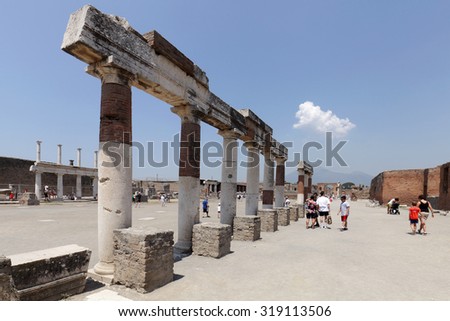 NAPLES, ITALY - JULY 17: Tourists visit the excavated ruins of Pompeii city on July 17, 2015, Naples, Italy. The city was buried under ash and debris during the eruption of Mount Vesuvius in 79 AD