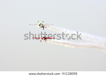 MUHARRAQ, BAHRAIN -DECEMBER 17: Stunts pilots from The Champions Aerobatic Show (TCAS) perform on December 17, 2011 on the occasion of Bahrain 40th National Day at Busaiteen beach in Muharraq, Bahrain