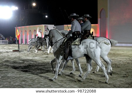 SAKHIR, BAHRAIN - MARCH 26: Horses of Royal Andalusian School of Equestrian Art performs on March 26, 2012 in Bahrain International Endurance Village during the Bahrain Animal Production Show 2012