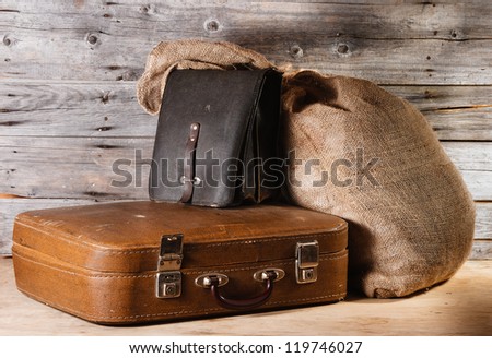 Luggage - ancient suitcase, leather bag and burlap sack