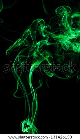 Smoke painted by green light forming an abstract figure