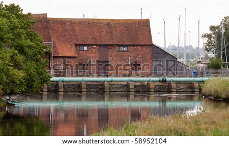 The old tide mill at Eling at the edge of the New Forest The mill traps the water in a pond at high tide and uses the energy as it drains back during low tide.