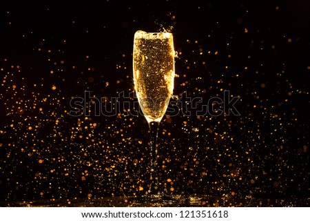 Champagne pouring in glass on a black background