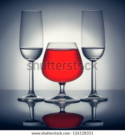 Stylish composition of three glasses of champagne and cognac