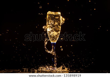 Champagne pouring in glass on a black background