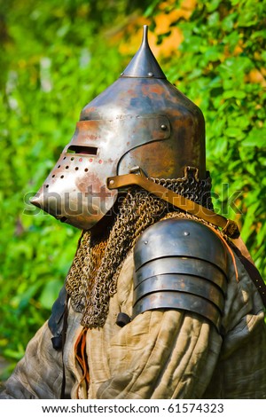 man in knight\'s helmet on a green background