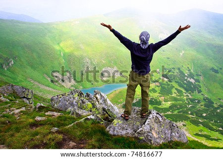 Beautiful mountains landscape with lake  in Carpathian mountains and man on the top
