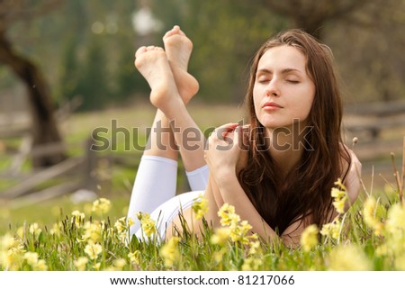 Young woman lying on field dreaming summer day