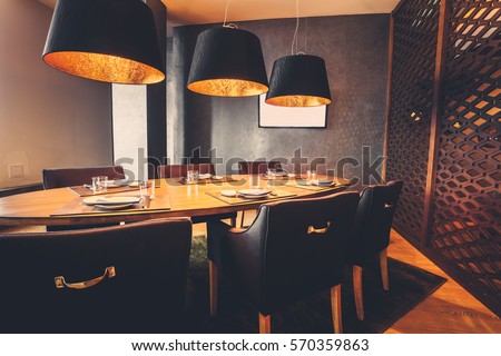 interior of restaurant with big lamps in golden light