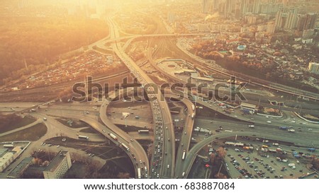 Aerial Drone Flight View of freeway busy city rush hour heavy traffic jam highway. Top view. Cityscape in sunset soft light. Instagram vintage filter toning. Kiev, capital of Ukraine
