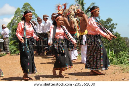 Cecer Village, Indonesia-Apr.21: Women perform a traditional dance in costume for tourists visiting the village on Flores Island on April 21, 2014.