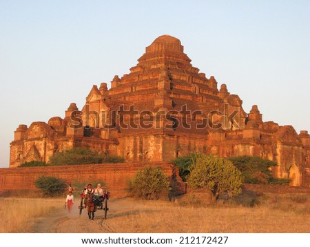 BAGAN, MYANMAR: JANUARY 1, 2010:  Tourists take a carriage ride at dusk at Bagan\'s largest Buddhist temple, Dhammayangyi.