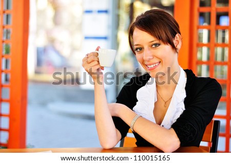 Attractive woman at the cafeteria with a cup of coffee