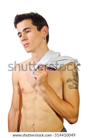 Confident young man with nude torso holding the shirt over the shoulder