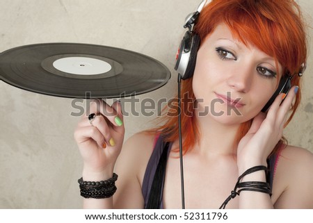 Young woman with vinyl and head phone