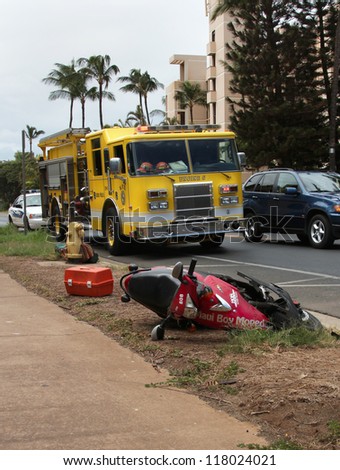 MAUI, HAWAII-JUL 26: Police and fire respond to traffic accident scene involving a motorscooter. Driver was injured and transported,on July 26, 2012 in Maui, Hawaii .