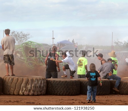 MAUI, HAWAII-DEC 9: Fans scramble to avoid wild rock crawler vehicle at Maui Motorsports Park on December 9, 2012 in Maui, Hawaii.