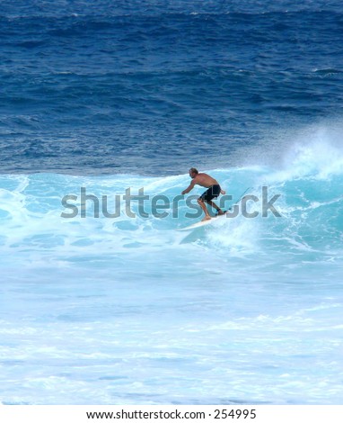 Surfer on an easy ride in Hawaii surf.