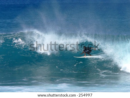 Surfer is in the tube on Maui\'s north shore.
