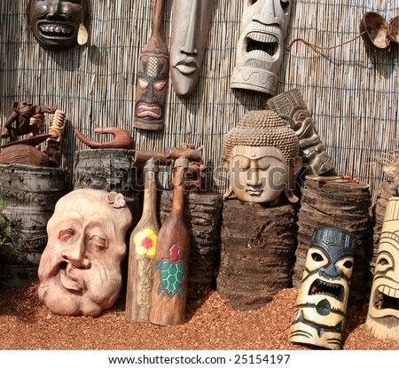 Carved decorative wood masks for sale to tourists at roadside stand in coastal Hawaii