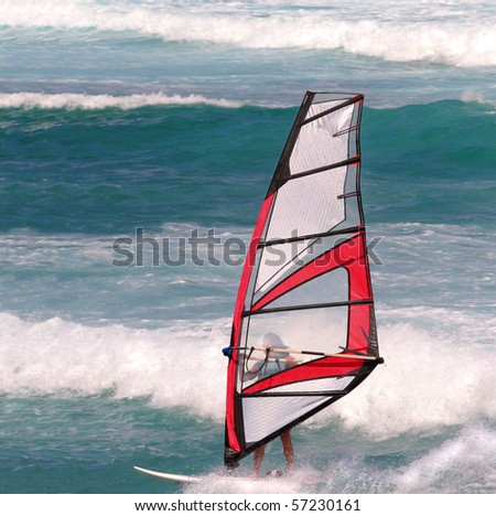 Woman windsurfer in active waves