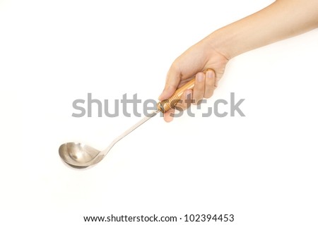 isolated hand holding a ladle or soup scoop for soup, for cooking or dining concepts.