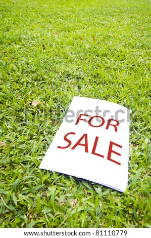 a for sale sign on grass field. For real estate background.