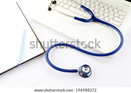 close-up of stethoscope, patient file, and pen resting on laptop, with lab test results beneath
