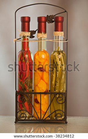 Three bottles filled with vegetables and oil for seasoning food