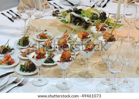 Elegant table setting in restaurant. Closeup of the luxurious dishes on a table.