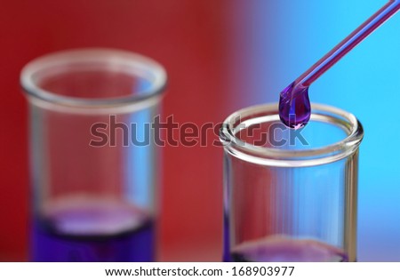 Macro of test tubes with dropper containing chemical
