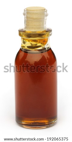 Mustard oil on a bottle over white background