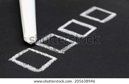 Check box by chalk in black slate