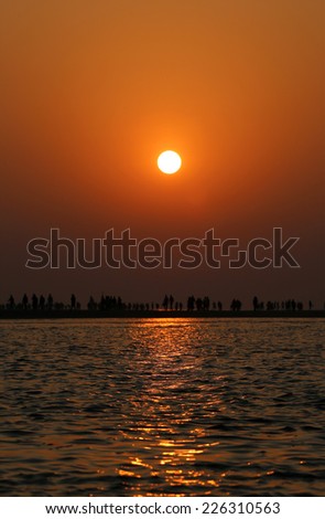 Sunrise on seashore with flying birds at Kuakata, Bangladesh