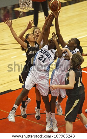 FREDERICTON, CANADA - AUGUST 11: Manitoba and Quebec players go for the rebound in the Canadian 15U girls basketball championship game August 11, 2012 in Fredericton, Canada. Quebec won 77-56.
