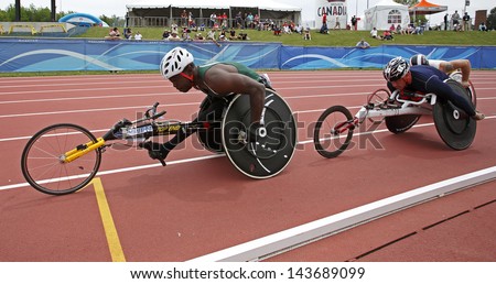 MONCTON, CANADA - June 22: Jean-Paul Compaore (left) and Michel Filteau compete in the 10,000-meter run wheelchair event at the Canadian Track & Field Championships June 22, 2013 in Moncton, Canada.