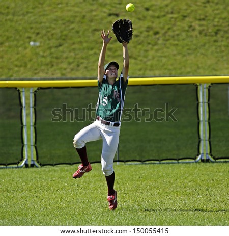 SHERBROOKE, CANADA - August 6: New Brunswick's Melissa Kenny makes a catch in women's softball at the Canada Games August 6, 2013 in Sherbrooke, Canada.