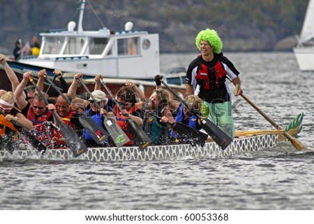 SAINT JOHN, CANADA - AUGUST 28: A sweep in a green wig steers his boat at the Saint John Dragon Boat Festival on August 28, 2010 in Saint John, Canada.